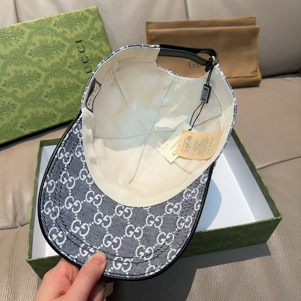 Gucci cap in dark blue with GG monogram pattern, cream interior lining visible