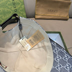 Gucci cap interior with GG monogram lining and hanging tags, curved brim edge
