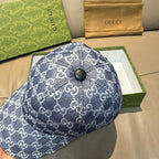 Gucci cap in dark blue with repeating GG monogram pattern, top with round button detail