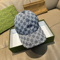Gucci cap in dark blue with repeating GG monogram pattern, curved brim, front view