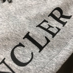 Stone Island shorts, light gray with large black logo text on the leg