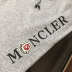 Stone Island shorts, light gray with black embroidered side text and logo patch