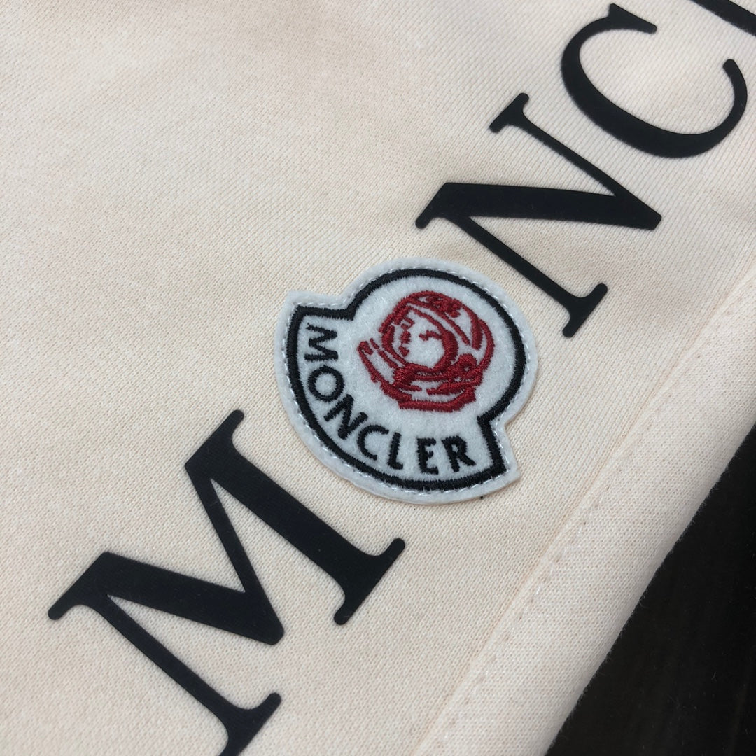Stone Island shorts detail of Moncler patch logo on cream fabric
