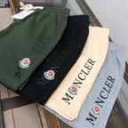 Stone Island shorts set with Moncler logos in dark green, black, cream, and gray