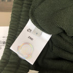 Dark green Moncler shorts with textured fabric and size S label