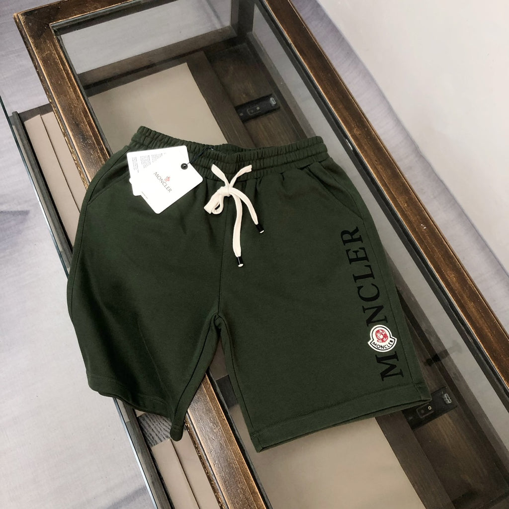 Dark green Moncler shorts with drawstring waist and side Moncler lettering logo