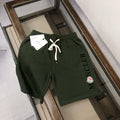 Dark green Moncler shorts with drawstring waist and side Moncler lettering logo