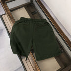 Dark green Moncler shorts with elastic waistband, front logo not visible