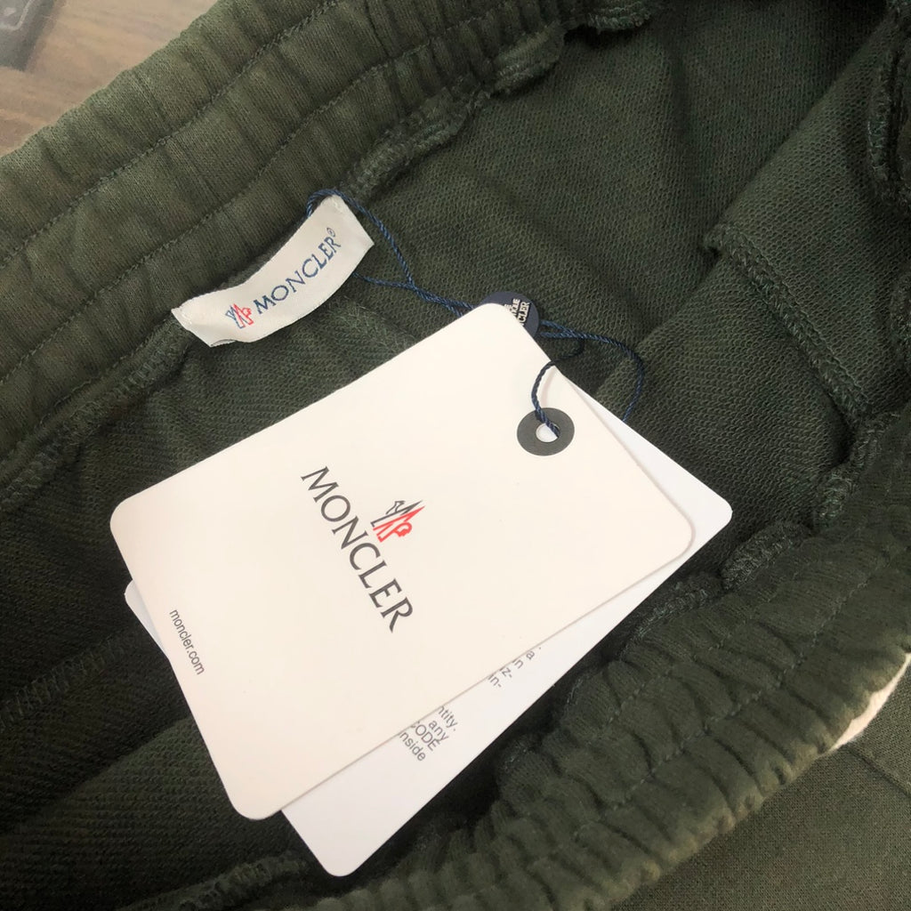 Dark green Moncler shorts with elastic waistband and hanging brand tag
