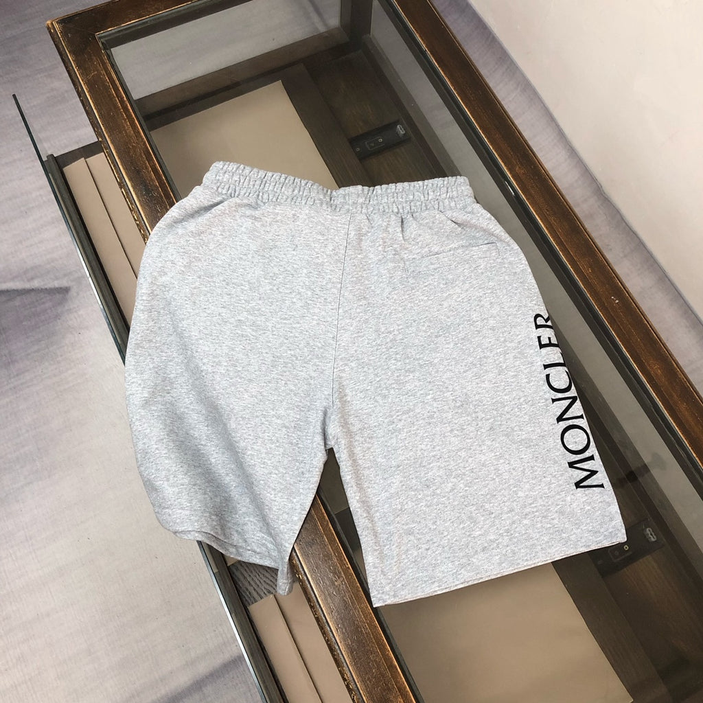 Heather gray drawstring shorts with vertical MONCLER text on the back