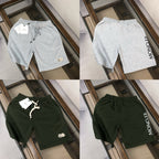 Four drawstring shorts: heather gray and dark green, with logo patches and ties
