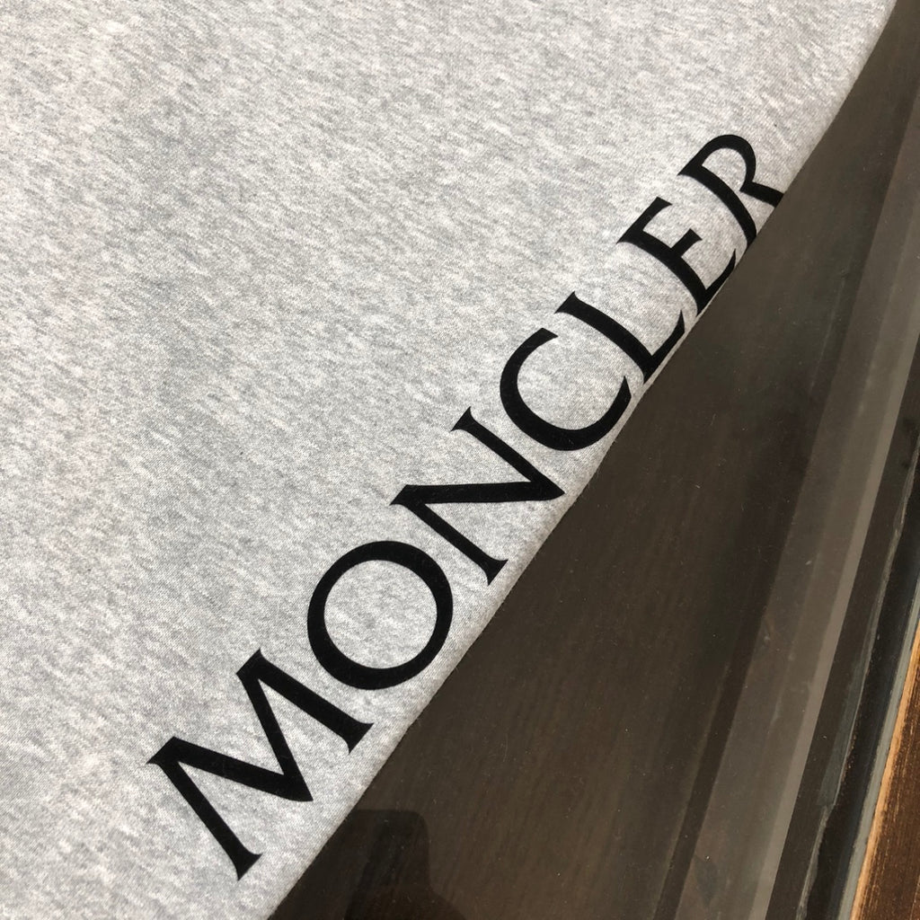 Back of heather gray drawstring shorts with large MONCLER text print