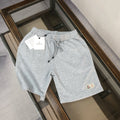 Heather gray drawstring shorts with small logo patch on the thigh