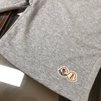 Heather gray drawstring shorts fabric with small logo patch near the hem