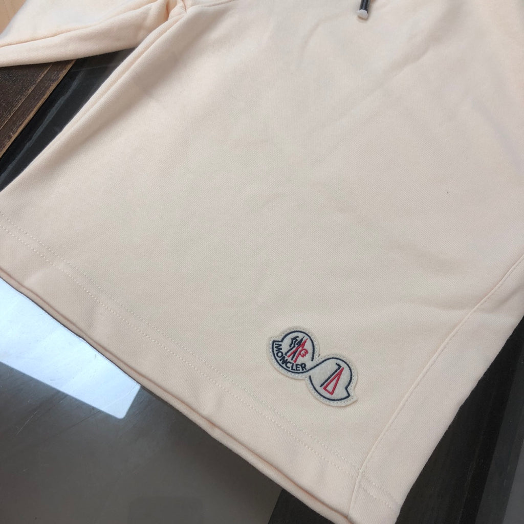 Moncler cream shorts with side logo emblem near hem