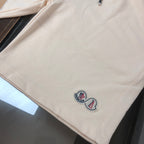 Moncler cream shorts with side logo emblem near hem