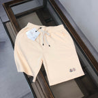 Moncler cream drawstring shorts with elastic waistband and small side logo patch