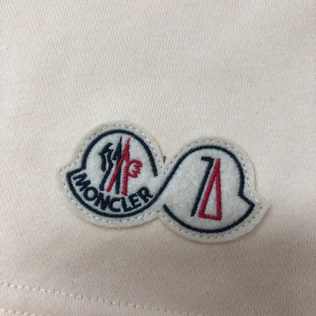 Moncler embroidered logo patch on cream fabric