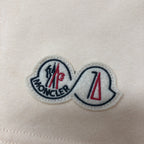 Moncler embroidered logo patch on cream fabric
