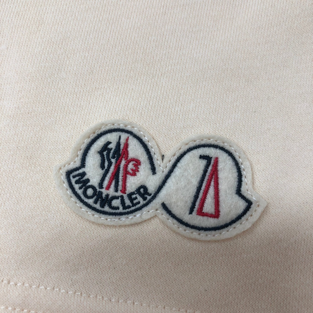Moncler embroidered logo patch on cream fabric