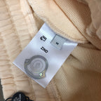 Moncler size label and care label inside cream shorts