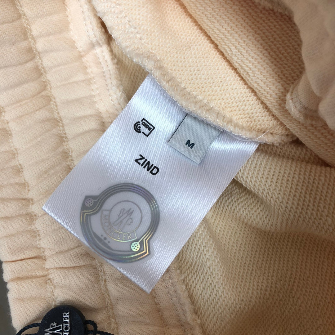 Moncler size label and care label inside cream shorts