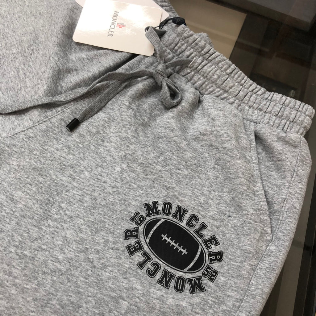 Gray shorts with elastic waistband, drawstring, and Moncler graphic patch