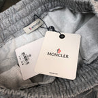 Gray shorts with Moncler-branded tags attached near waistband