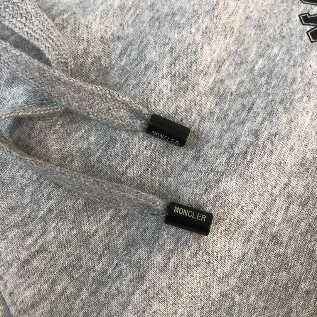 Gray shorts with Moncler labels on fabric cuffs