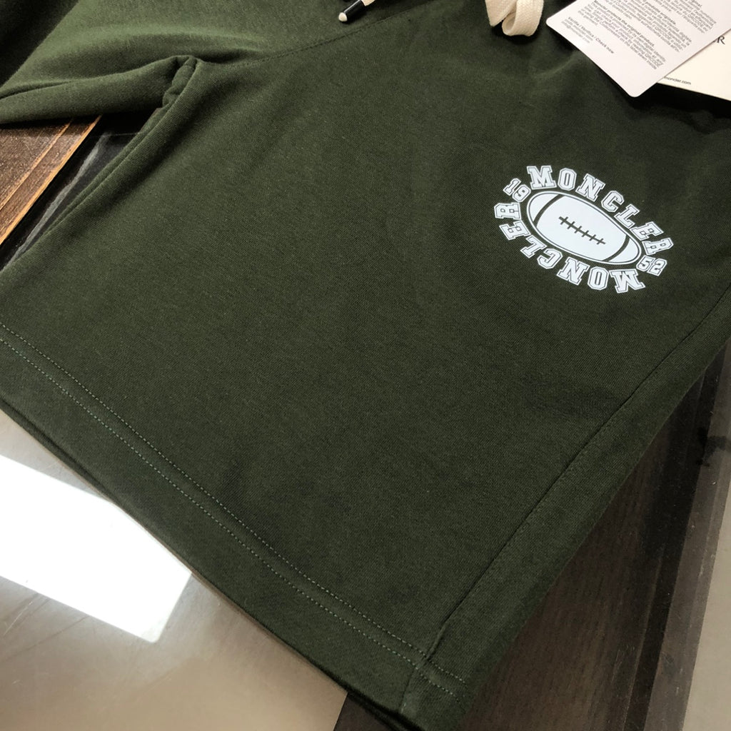 Stone Island dark green shorts with circular logo on the front leg