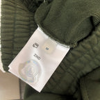 Stone Island olive green shorts with inside label near elastic waistband