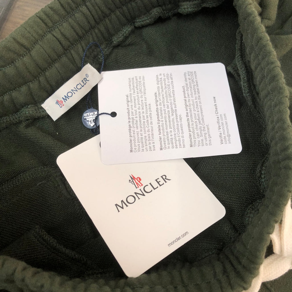 Stone Island dark green shorts with inner size and care tags at waistband