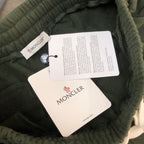 Stone Island dark green shorts with inner size and care tags at waistband