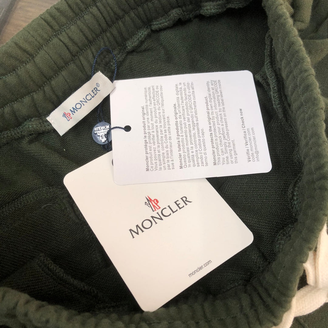 Stone Island dark green shorts with inner size and care tags at waistband
