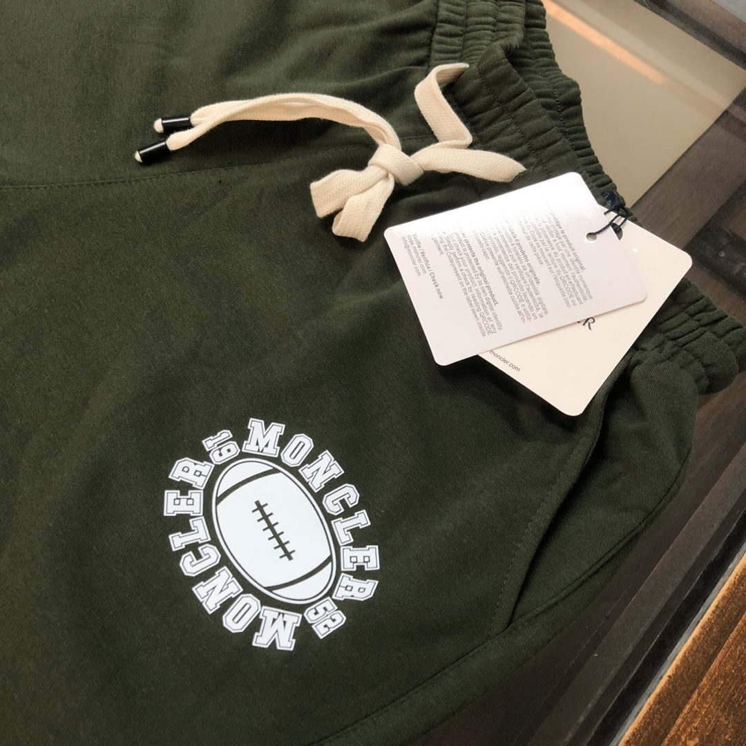 Stone Island olive green shorts with white drawstring and front logo