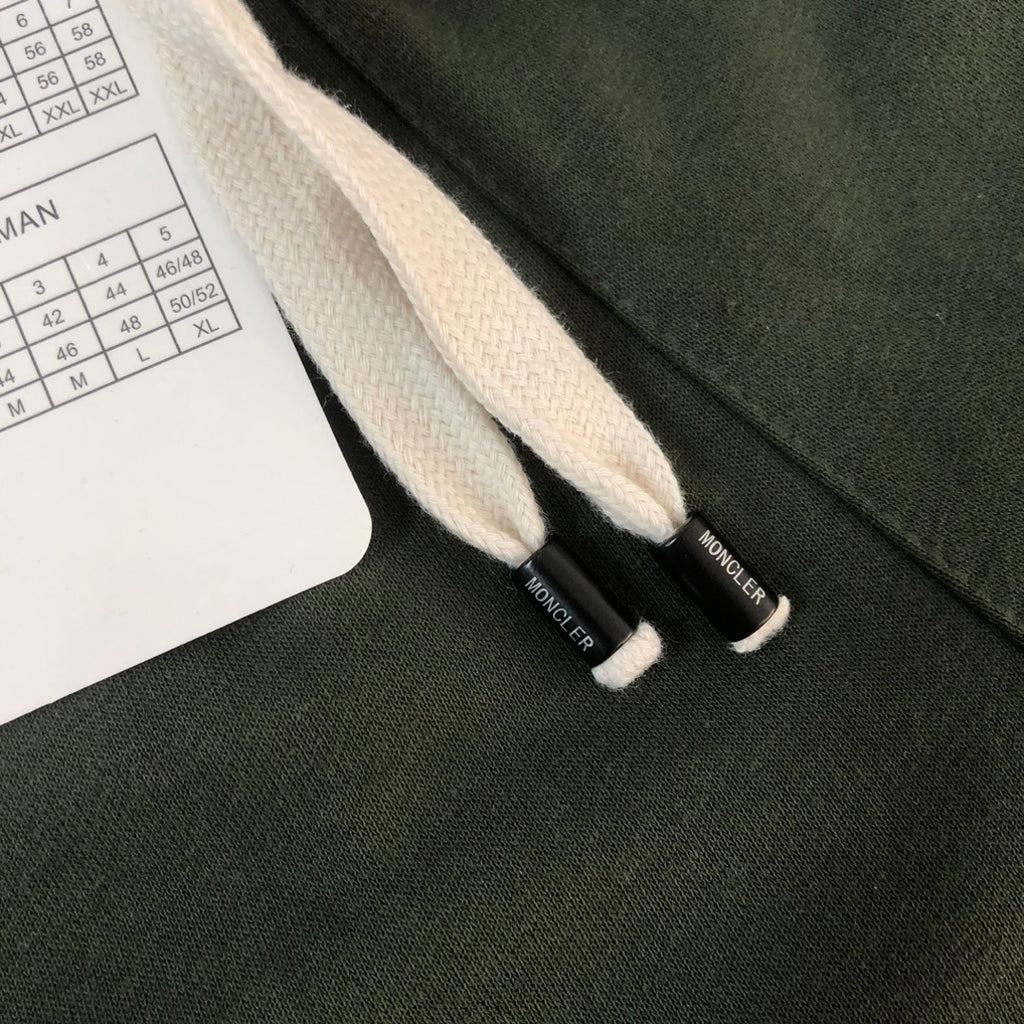 Stone Island dark green shorts with white drawstring ends and woven waistband