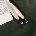Stone Island dark green shorts with white drawstring ends and woven waistband