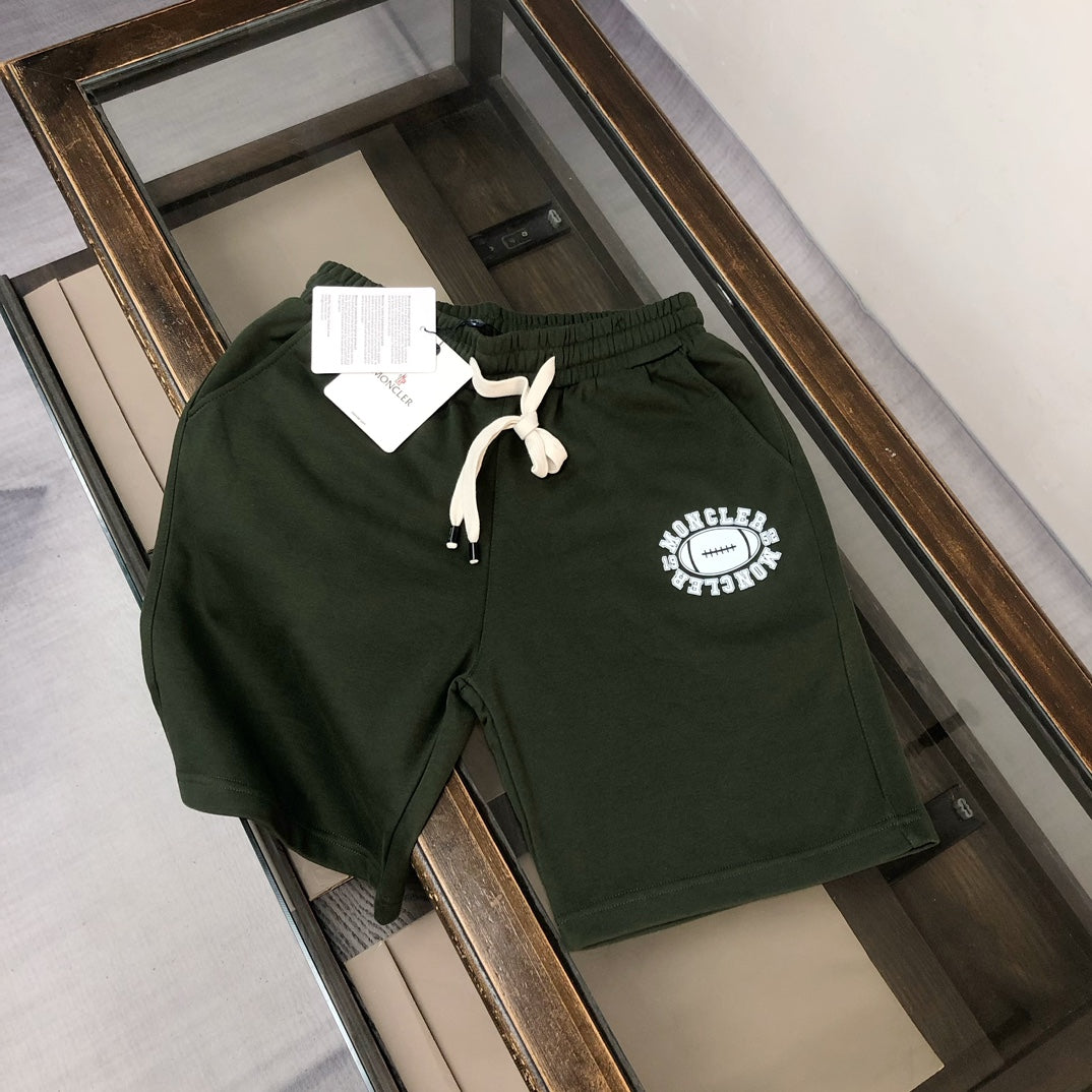 Stone Island shorts in dark green with white drawstring and circular logo patch