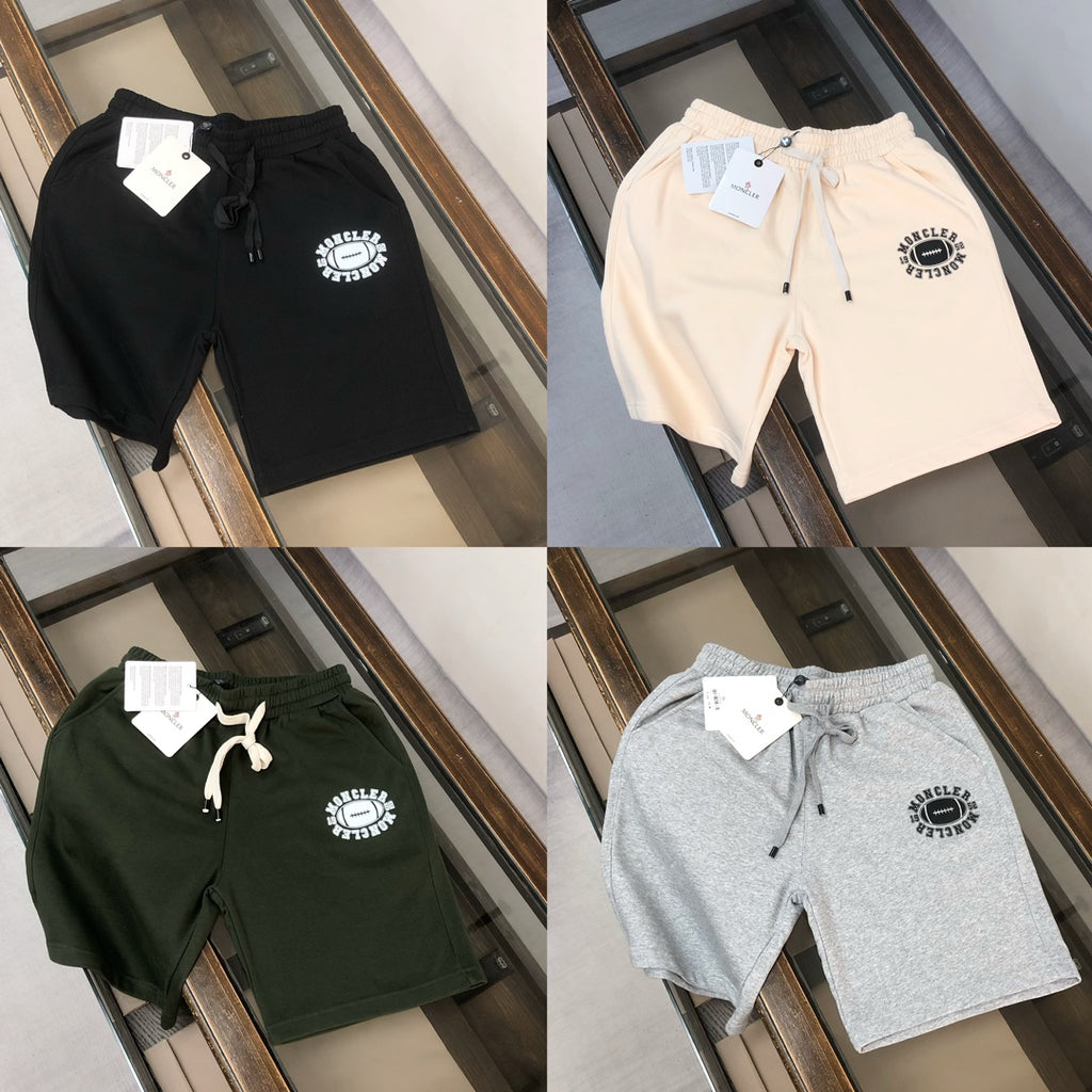 Four logo shorts in black, light beige, dark green, and gray on one display