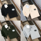 Four logo shorts in black, light beige, dark green, and gray on one display