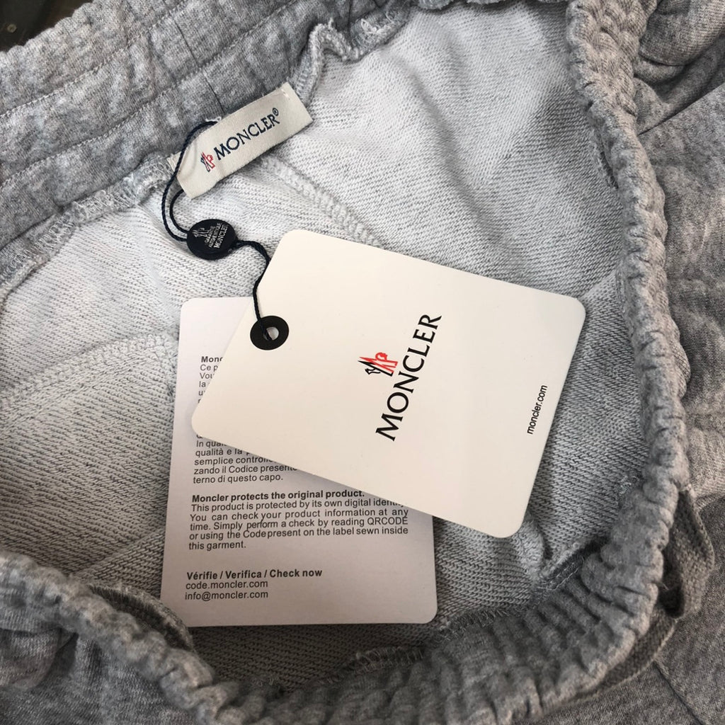Gray sweat shorts with Moncler tags on the inner waistband and drawstring