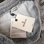 Gray sweat shorts with Moncler tags on the inner waistband and drawstring