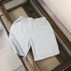 Light gray sweat shorts with elastic waist and small Moncler crest patch
