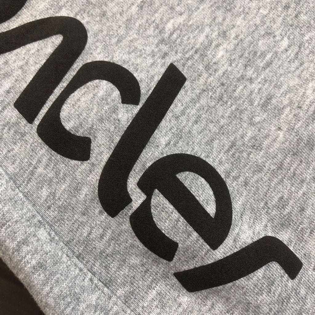 Gray shorts with large black Moncler logo lettering detail