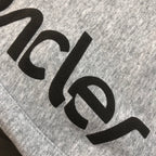 Gray shorts with large black Moncler logo lettering detail
