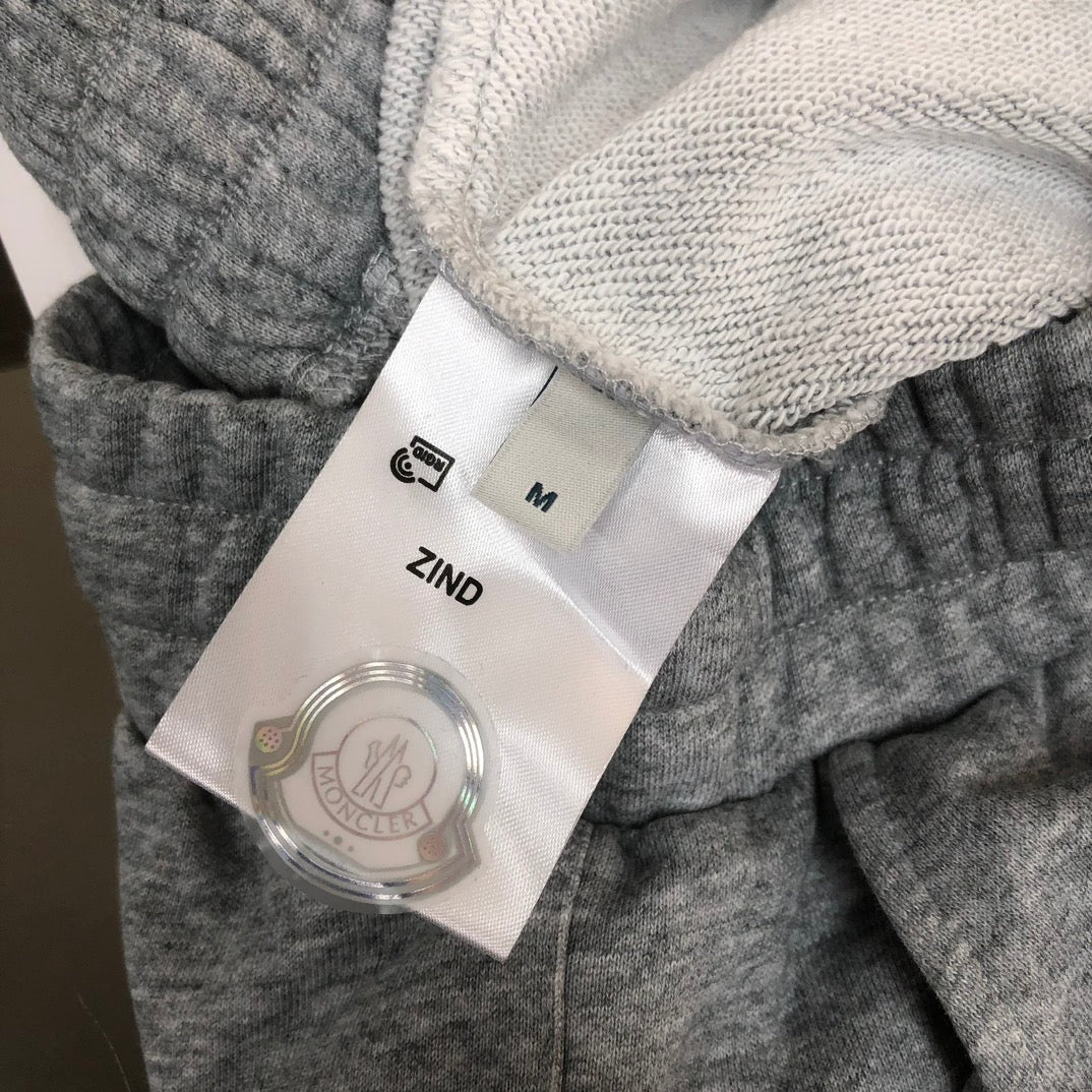 Gray shorts with size M label and “ZIND” tag inside waistband