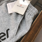 Gray sweat shorts with Moncler hang tag on the fabric