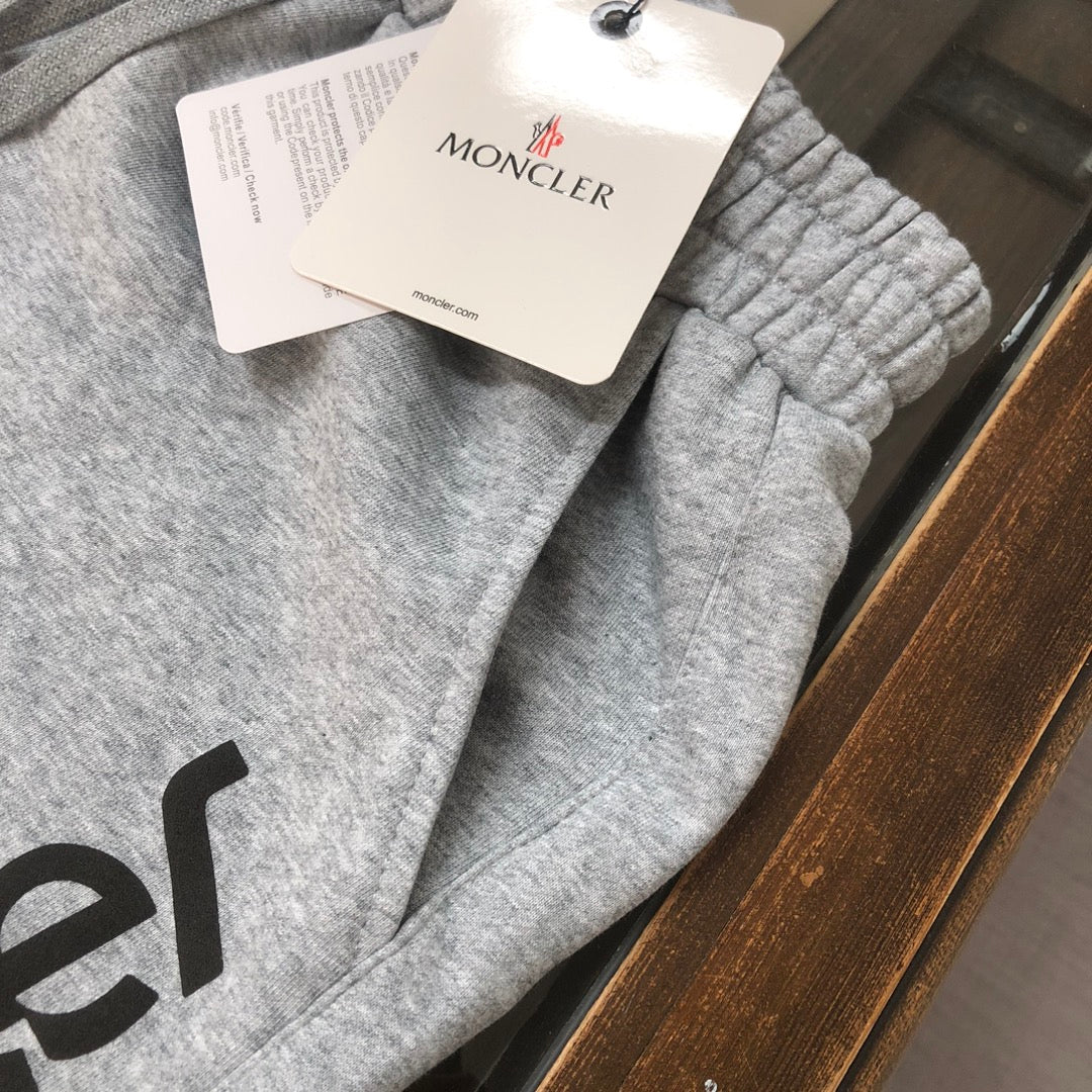 Gray sweat shorts with Moncler hang tag on the fabric