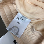 Stone Island shorts interior with size label and care tag on cream fabric