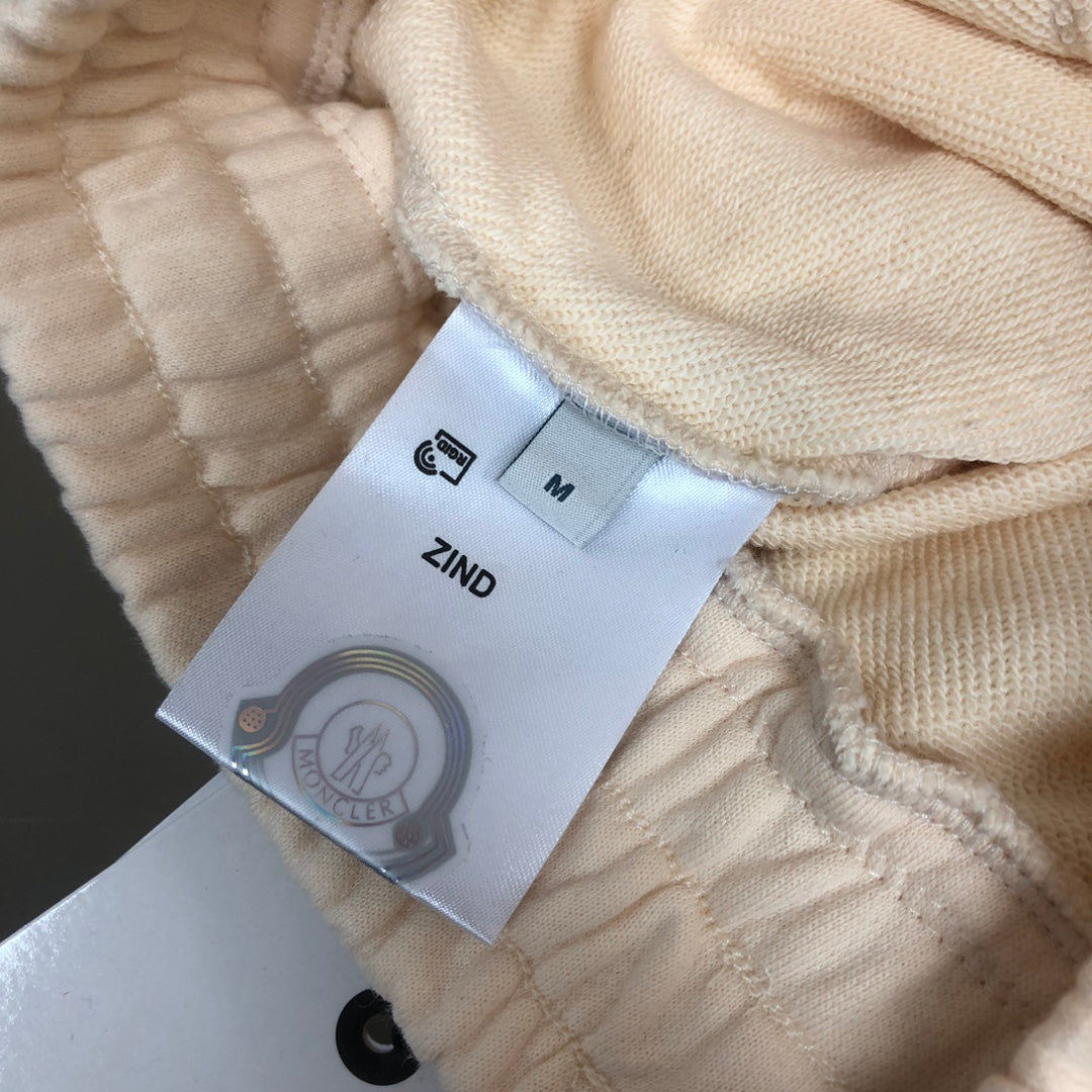 Stone Island shorts interior with size label and care tag on cream fabric